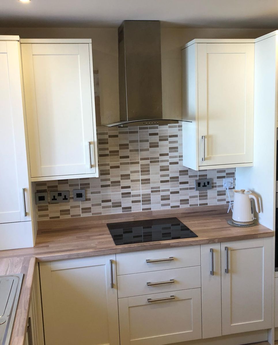 Cream country-style Howdens kitchen with wood worktops
